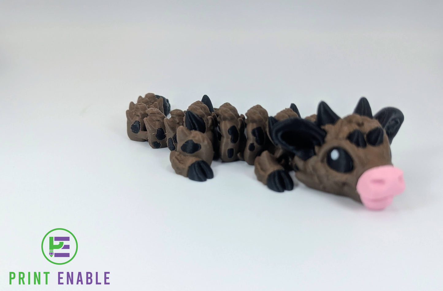 Close-up of Baby Cow Dragon showing expressive eyes, horns, and articulated body