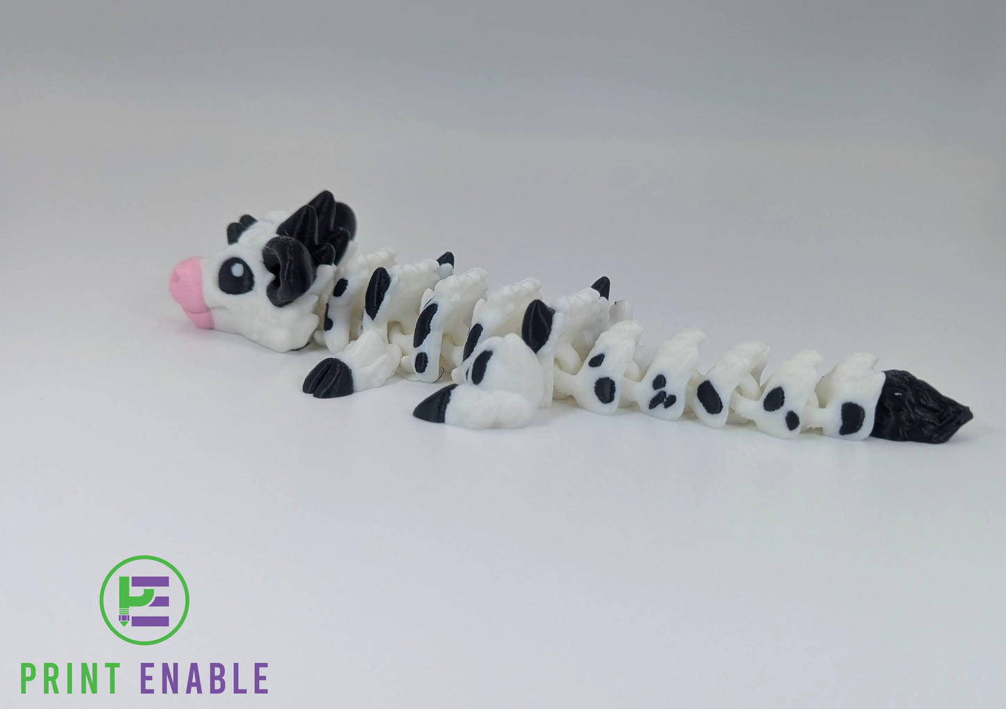 Full body view of articulated Baby Cow Dragon collectible displayed on white background