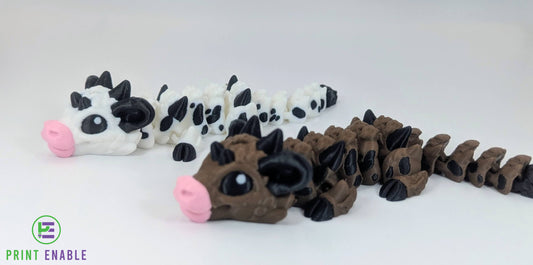 Baby Cow Dragon shown in multiple colour options including brown and black-and-white variants