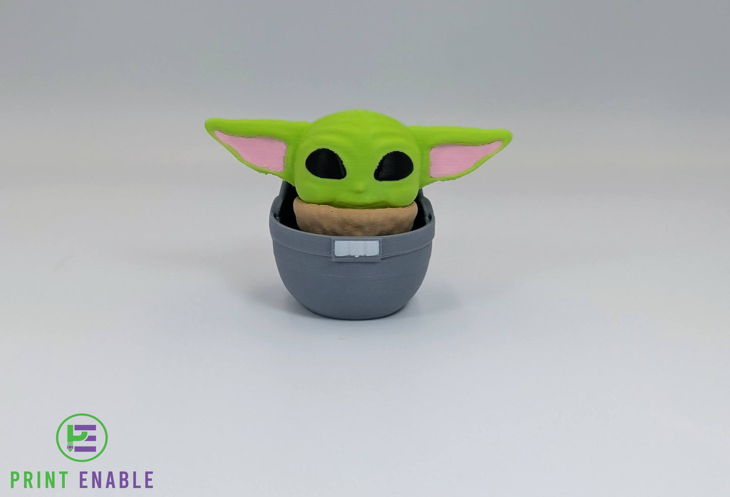 Baby Grogu 3D printed fidget clicker keychain sitting in a floating pod with a satisfying mechanical click action.