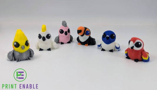 Bird Hatchling articulated 3D printed fidgets shown in multiple colourful bird-inspired designs