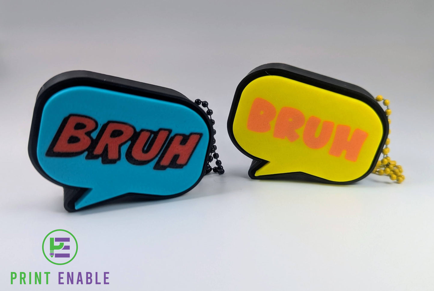 Bruh clicker fidget keychains in multiple colour variations including blue and yellow designs