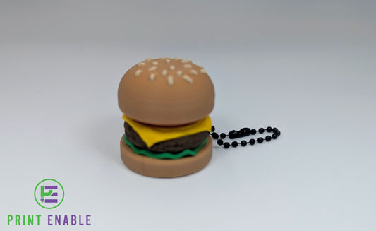 Burger Clicker keychain fidget featuring a miniature cheeseburger design.