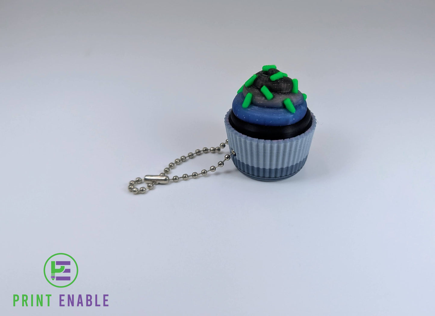 Cupcake clicker fidget with dark frosting and green sprinkle details