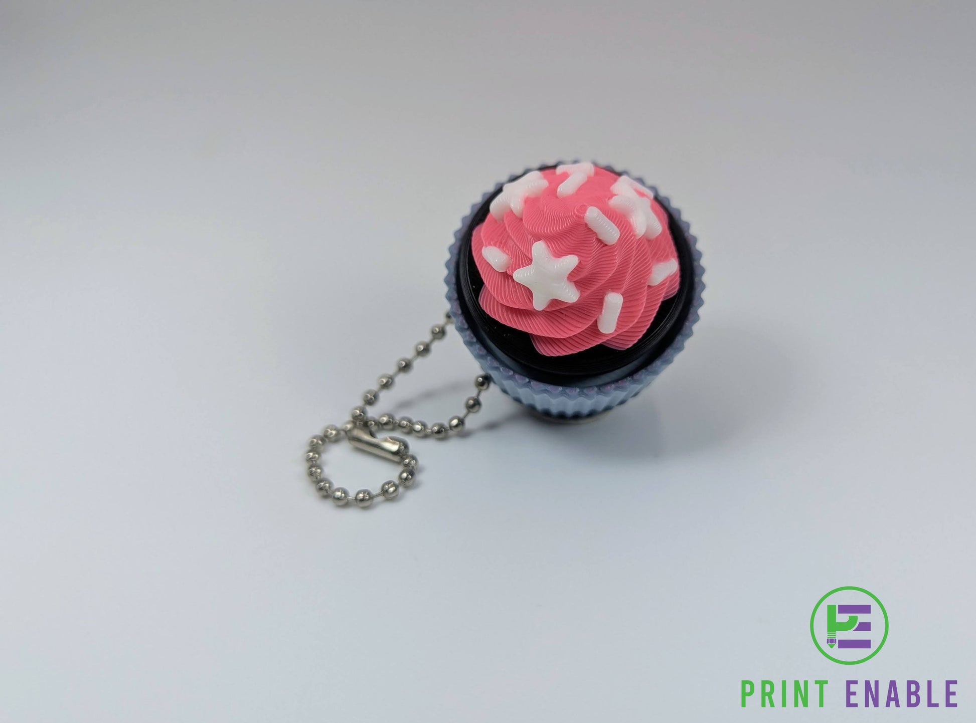 Cupcake clicker fidget with pink frosting and white sprinkle decorations