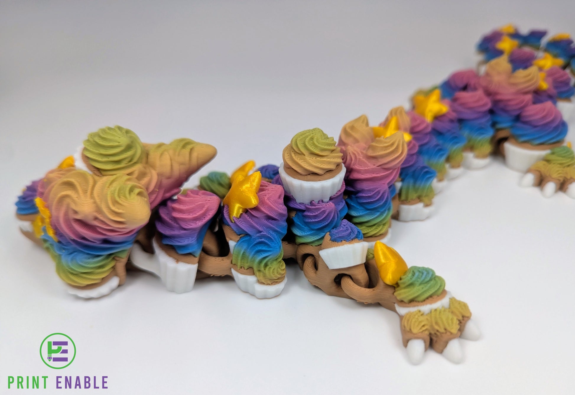 Side view of a colourful Cupcake Dragon showing articulated body sections and cupcake-inspired details.
