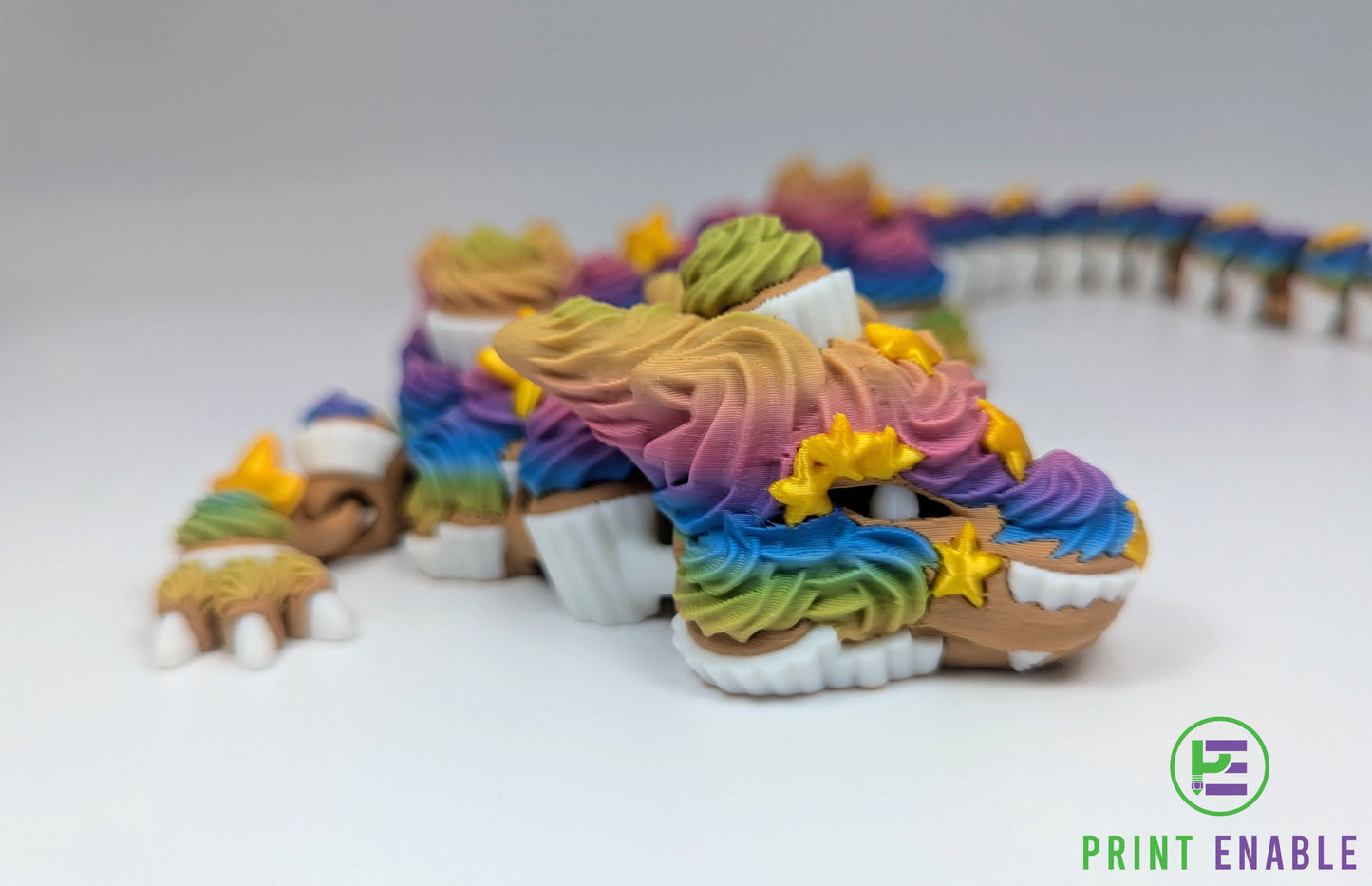 Close-up of the Cupcake Dragon head featuring detailed frosting textures, cupcake accents and golden stars.