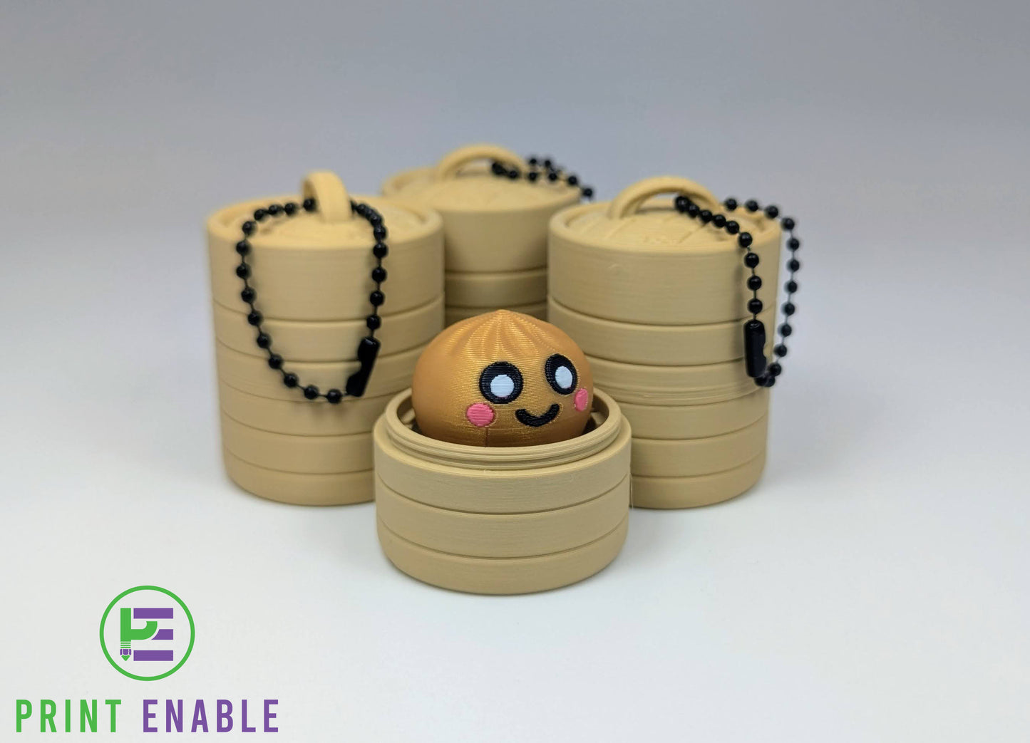 Rare gold Dumpling Clicker displayed with keychain versions in bamboo-style baskets