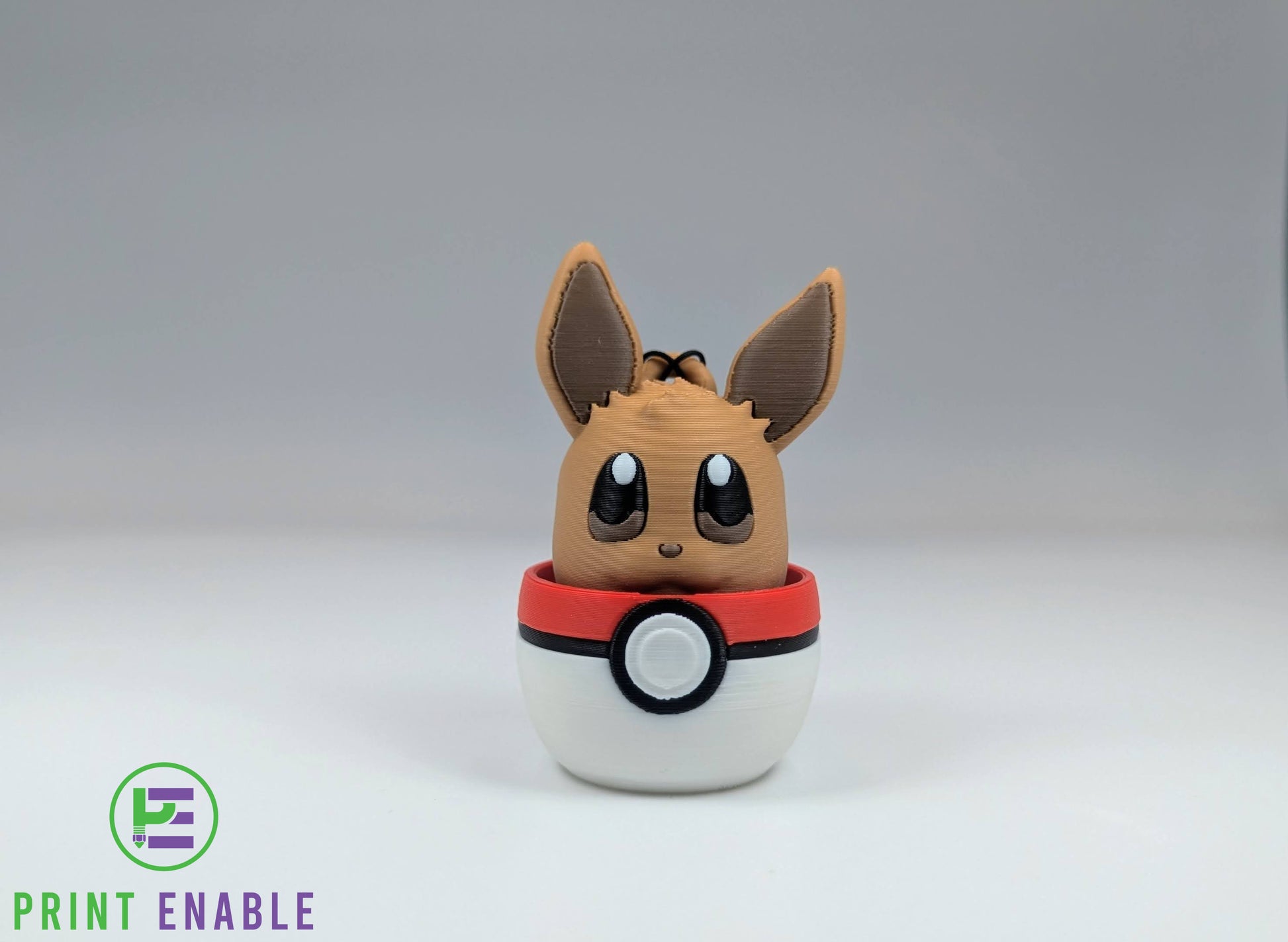 Eevee 3D printed character fidget clicker keychain emerging from a ball with a satisfying mechanical click action.