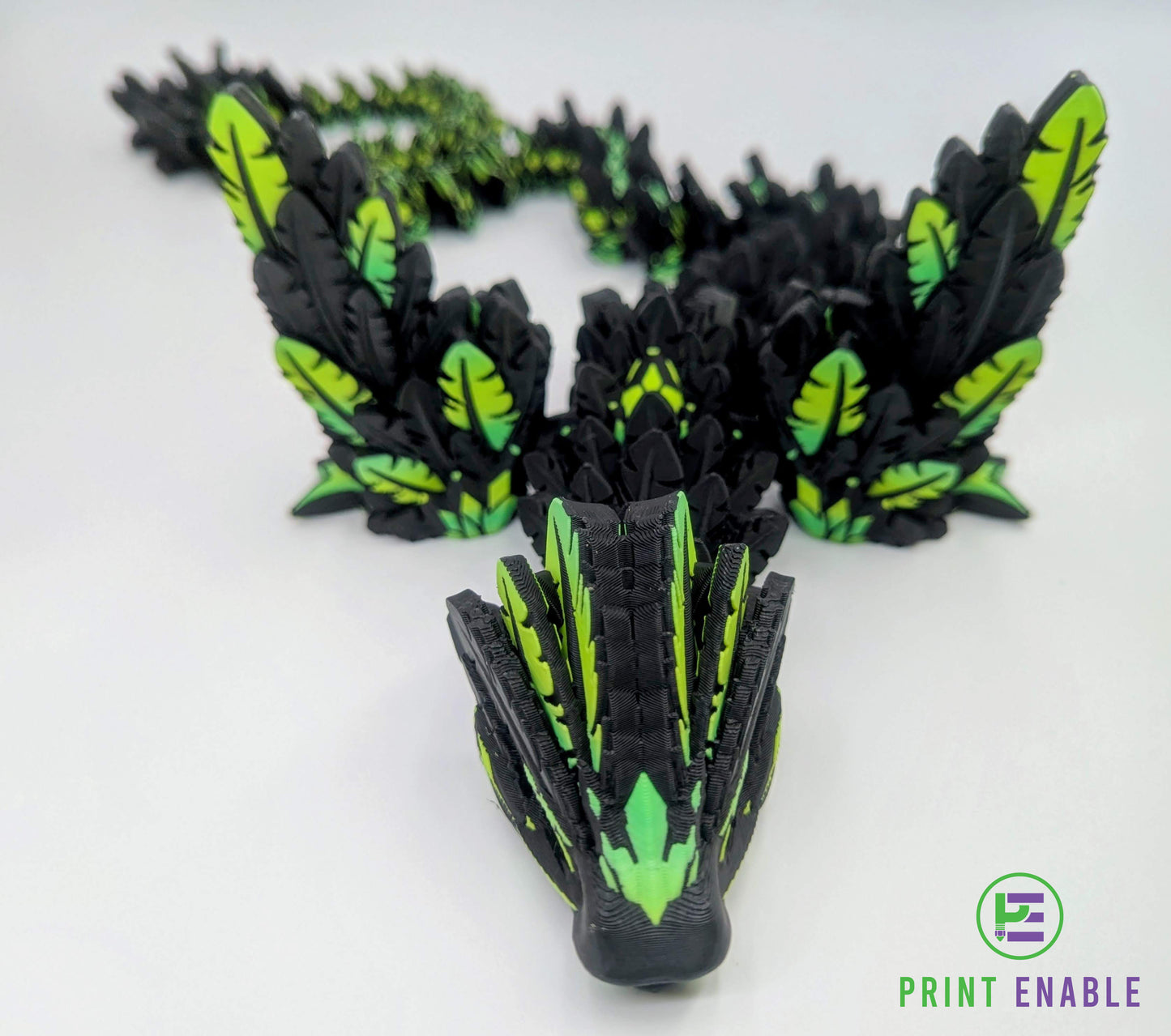 Black and green Flying Serpent articulated dragon posed in a curved display position