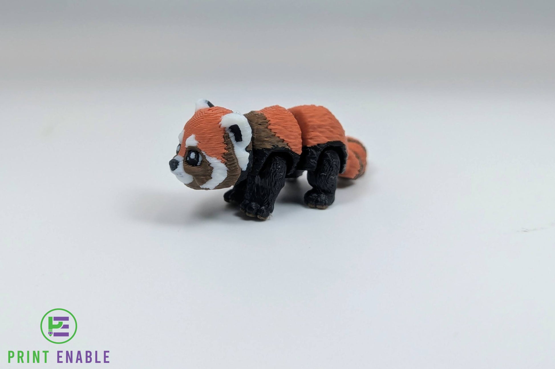 Red Panda Hatchling articulated 3D printed fidget side view showing fluffy tail and body detail