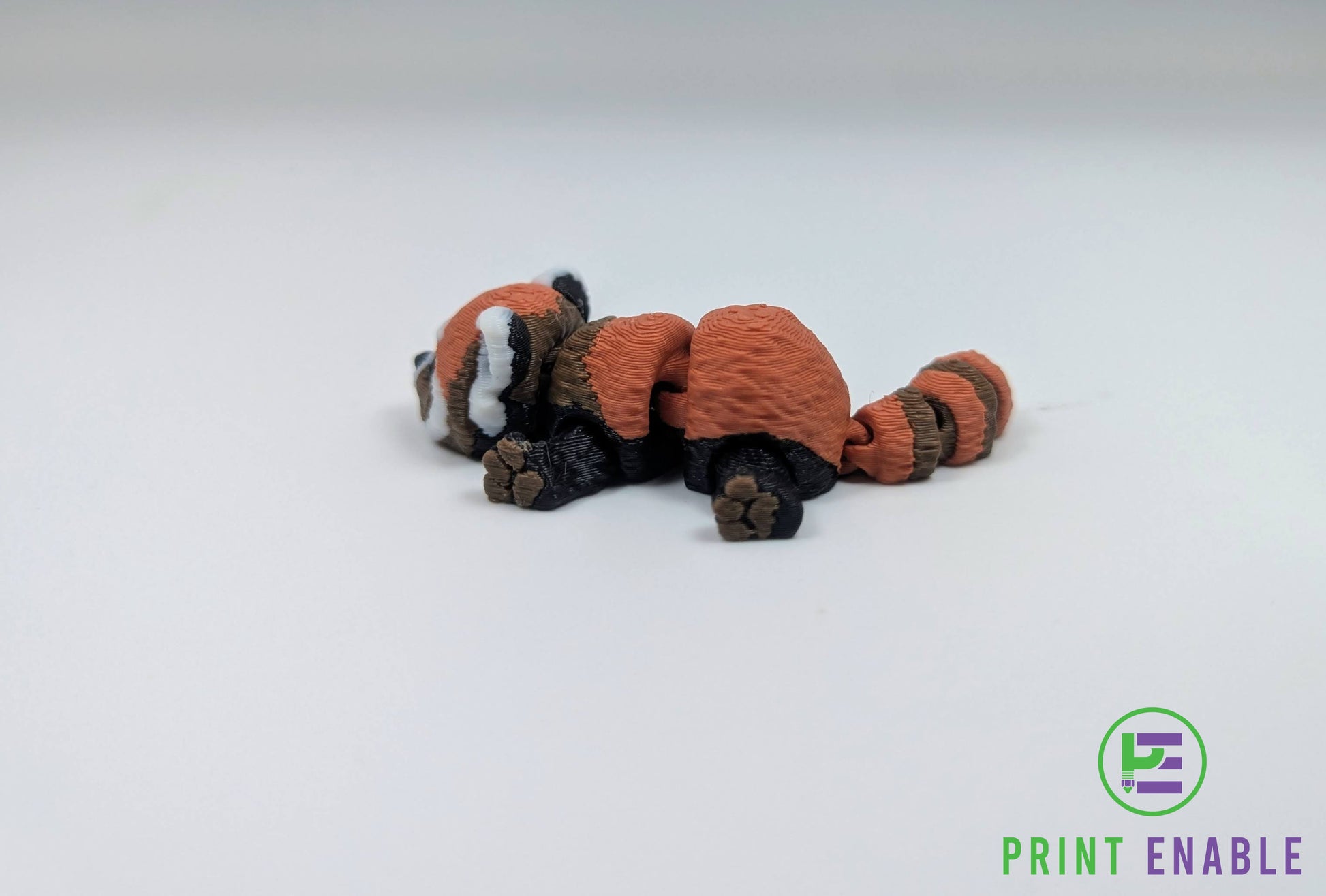 Red Panda Hatchling articulated 3D printed fidget back view showing articulated body segments and striped tail