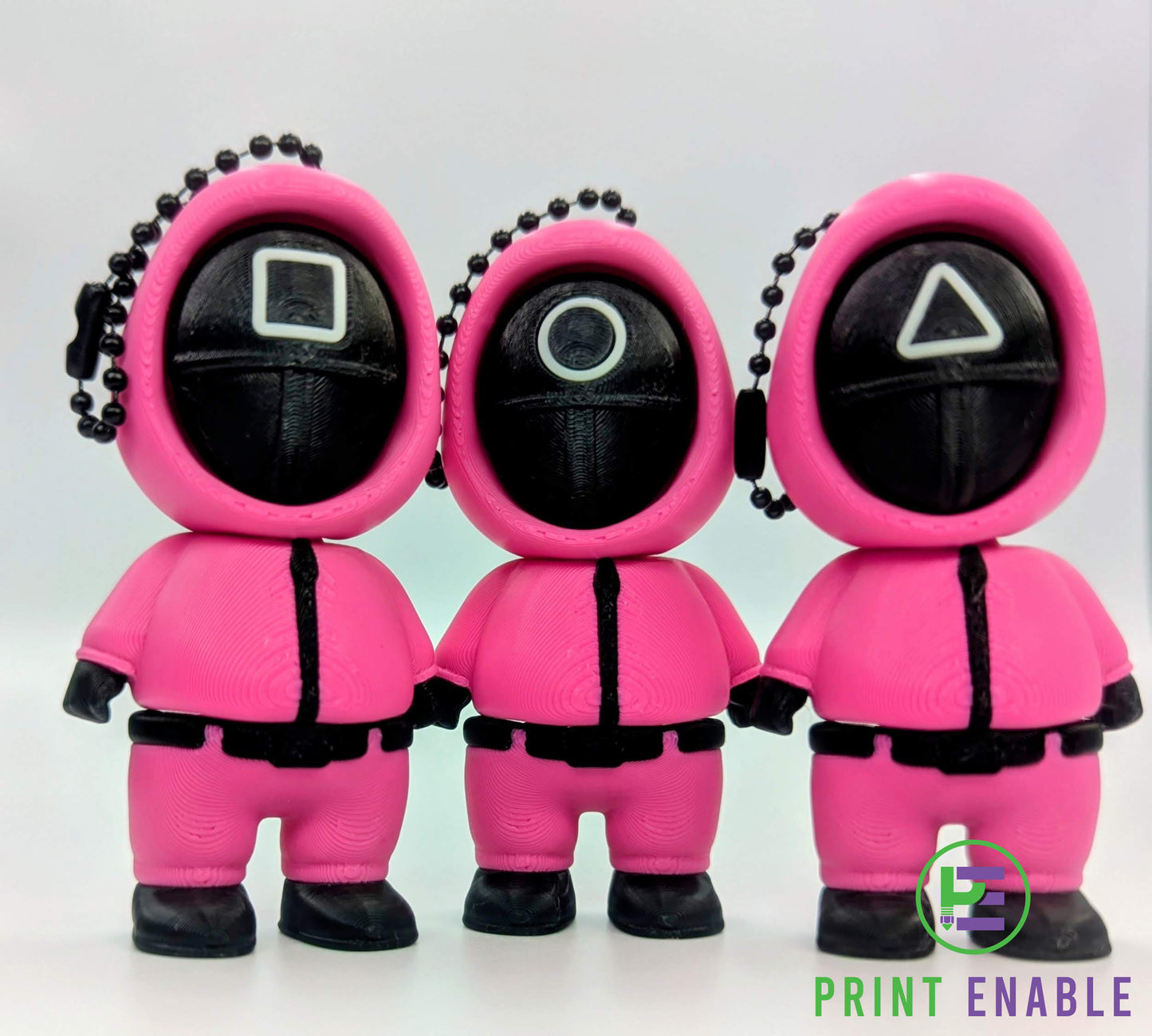 Set of Squid Games-inspired guard clicker keychains with square circle and triangle masks