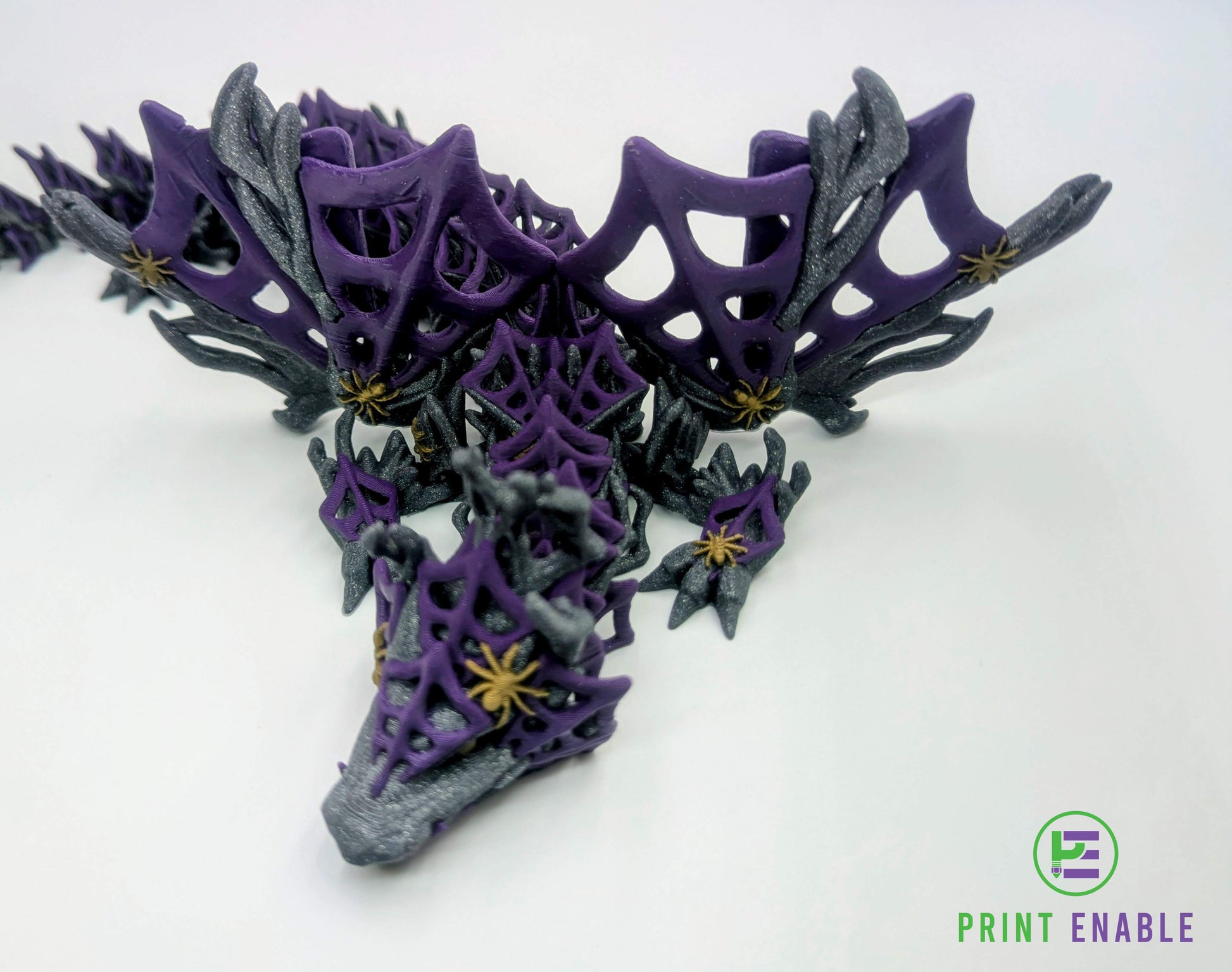 Close-up of a purple and silver Wickedwing Dragon highlighting web textures and spider accents.