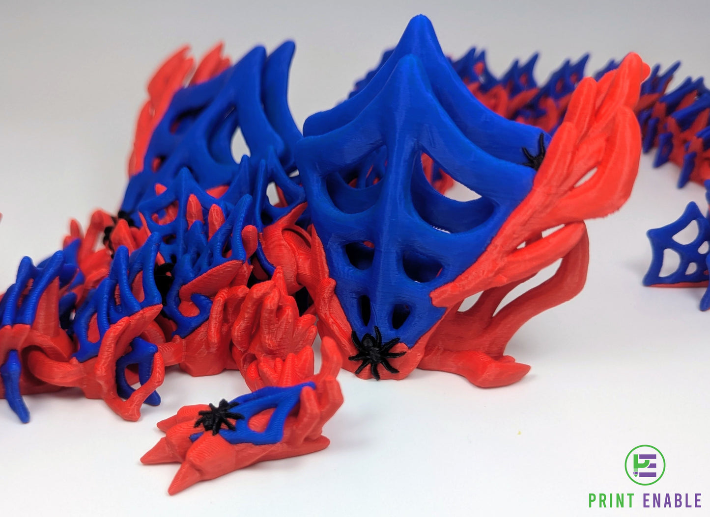 Red and blue Wickedwing Dragon with articulated body, web-like wings and detailed spider accents.