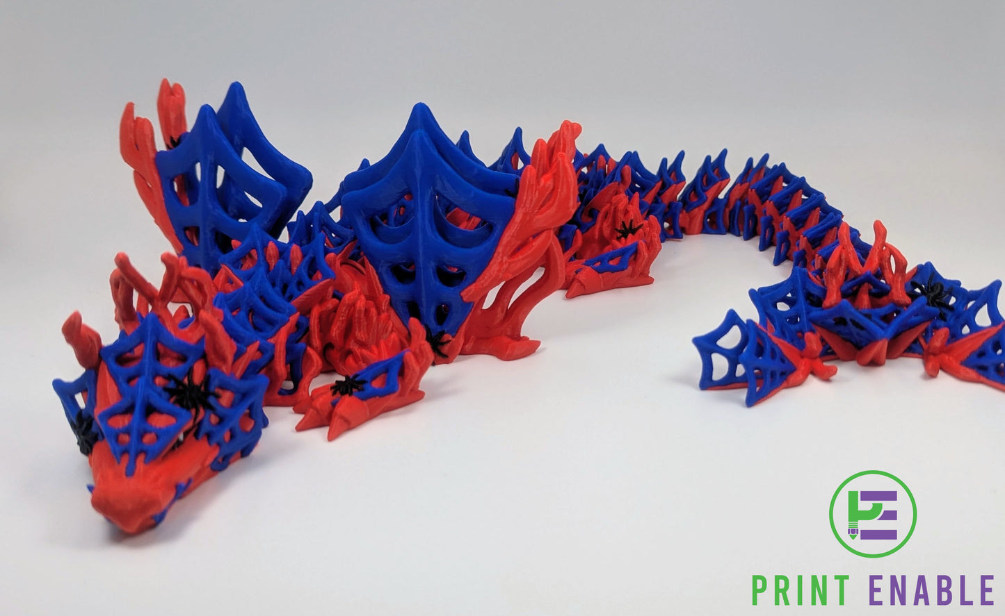 Articulated Wickedwing Dragon in red and blue colours displaying its full body and web-inspired design.